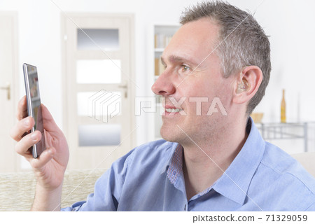 Deaf man using sign language on the smart phone Deaf man using sign language on the smart phone 71329059