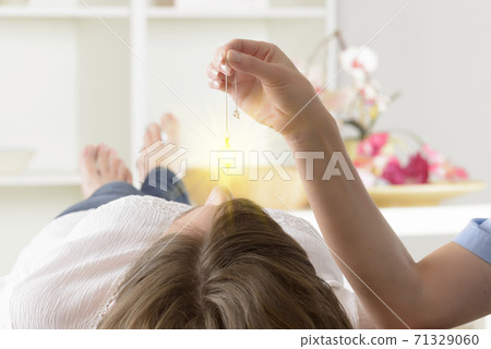 Therapist using pendulum to make a diagnosis 71329060