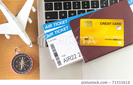 Air tickets and passports near laptop computer and airplane on table. Online ticket booking concept 71331618