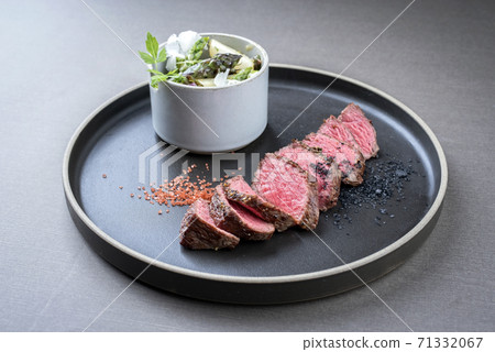Modern barbecue dry aged sliced filet steak with spring salad and green and white asparagus 71332067