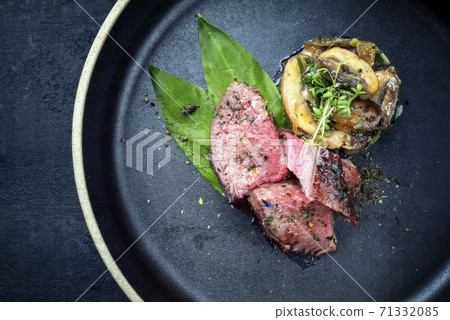 Traditional barbecue dry aged sliced venison filet steak with potato mushroom terrine Traditional barbecue dry aged sliced venison filet steak with potato mushroom terrine 71332085