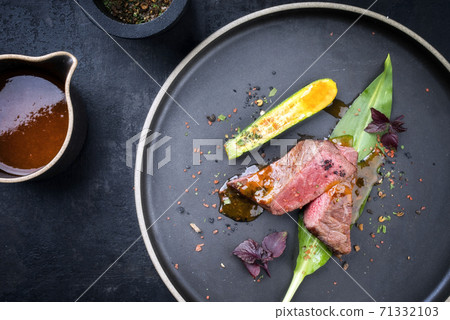 dry aged sliced fillet steak with wild garlic and baby zucchini  71332103