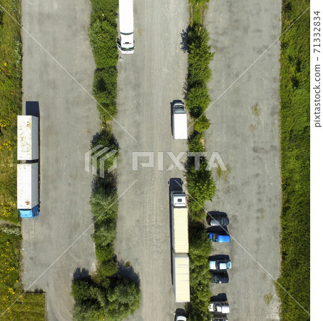 almost empty asphalted grey parking lot with two trucks almost empty asphalted grey parking lot with two trucks 71332834