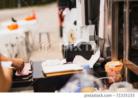 Woman cashire changing money at cash register in her hand. Woman cashire changing money at cash register in her hand. 71335155