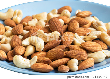 Mix of cashew and almond nut on blue plate Mix of cashew and almond nut on blue plate 71335157