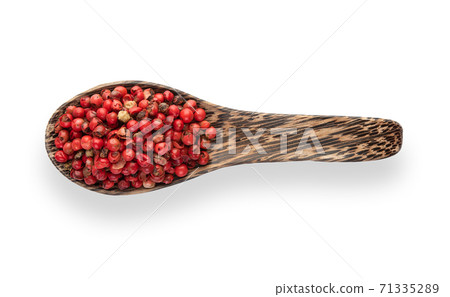 dried pink peppers in wood spoon isolated on white background. Top view 71335289