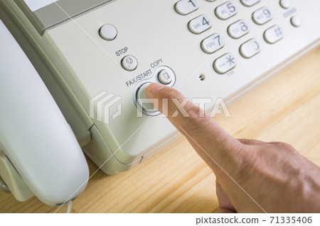 hand man are using a fax machine in the office, equipment for data transmission. 71335406