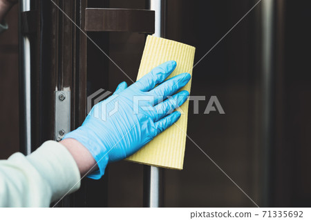 Cleaning and sanitizing  door entrance from bacteria and virus 71335692