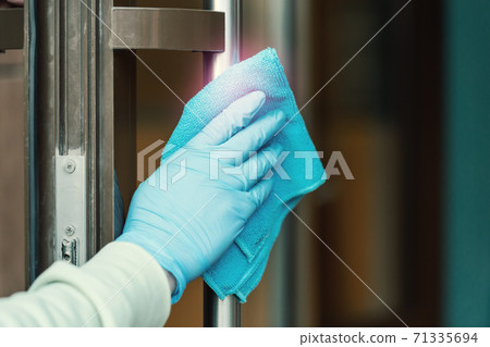 Cleaning and sanitizing  door entrance from bacteria and virus 71335694
