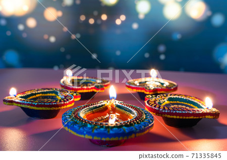 Indian festival Diwali, Diya oil lamps lit on colorful rangoli. Hindu traditional. Happy Deepavali. Copy space for text. 71335845