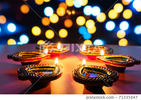 Indian festival Diwali, Diya oil lamps lit on colorful rangoli. Hindu traditional. Happy Deepavali. Copy space for text. 71335847