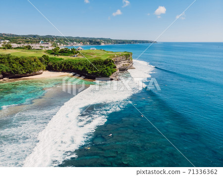 Blue ocean and cliff at background. Aerial view of tropical island with waves Blue ocean and cliff at background. Aerial view of tropical island with waves 71336362