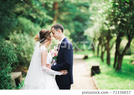 Gorgeous happy couple standing close to each other and looking in eyes 71336657