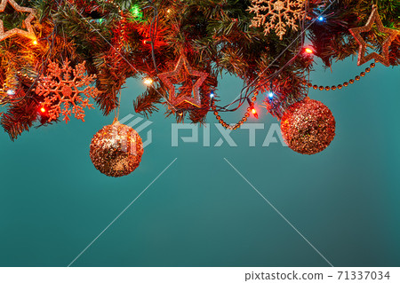 Christmas tree branch with stars, balls and garland. 71337034