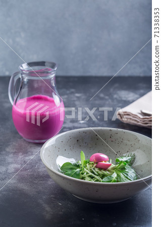 Traditional cold summer beetroot soup with vegetables in a white bowl. Traditional cold summer beetroot soup with vegetables in a white bowl. 71338353