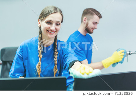 Man and woman team of commercial cleaners working Man and woman team of commercial cleaners working 71338826