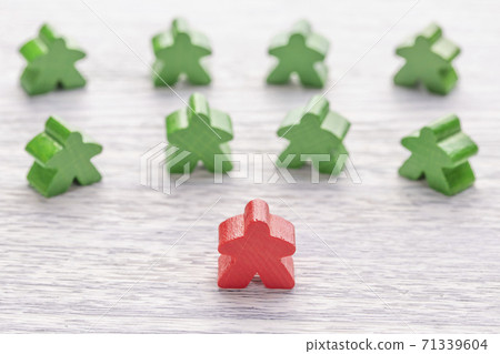 Among others, a red wooden figure in the shape of a man stands out. Number one. Leadership skills. Boss. CEO. Bright table. The concept of intelligent team management 71339604