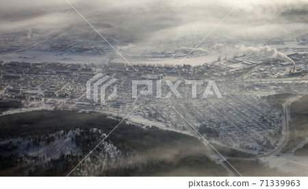 Ust-Kut on the Lena river in winter in a frosty fog and haze. 71339963