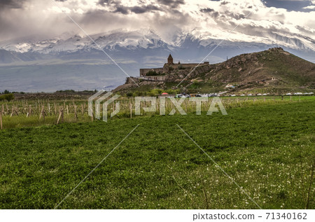 Khor Virap fortress on a rocky hill in the Ararat valley against the background of clouds descending on mount Ararat Khor Virap fortress on a rocky hill in the Ararat valley against the background of clouds descending on mount Ararat 71340162