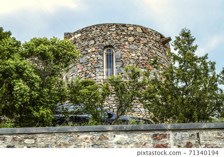 Medieval fortress of Khor Virap and round tower made of rough stone among the trees in Armenia 71340194