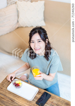 Woman eating fruit and relaxing 71340260