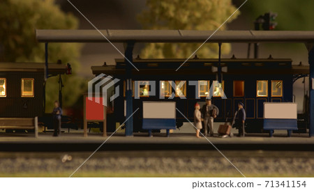 Retro miniature railway station with passangers. Retro miniature railway station with passangers. 71341154