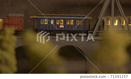 Miniature retro train on the bridge. Miniature retro train on the bridge. 71341157