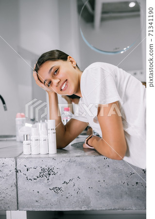 painting of a woman with cosmetic bottles in the bathroom 71341190