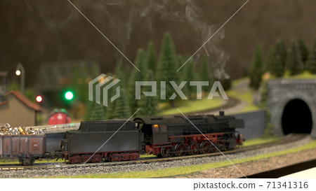 Side view black toy lokomotive. 71341316