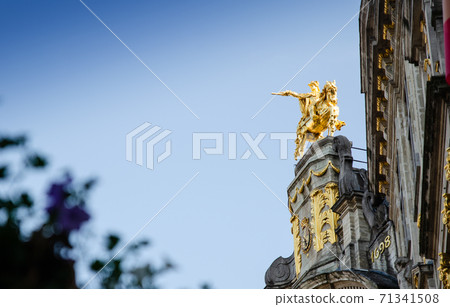 Brussels, Belgium, August 2019. The Great Square or Grote Markt. The evening light enhances its beauty of the magnificent Baroque and Gothic buildings. In evidence the golden equestrian statue 71341508