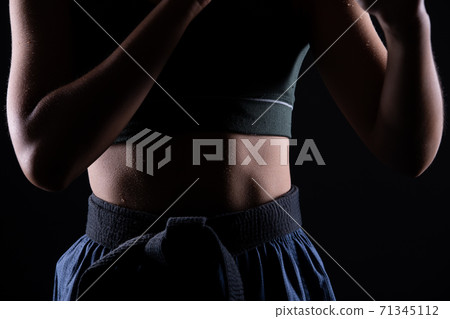 TaeKwonDo Karate teenager athlete kick punch black background isolated 71345112