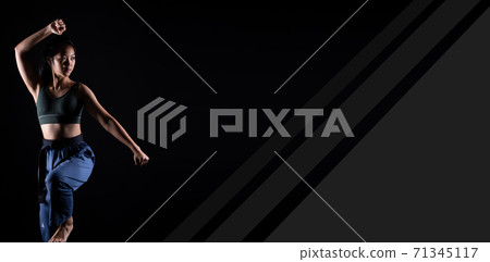 TaeKwonDo Karate teenager athlete kick punch black background isolated 71345117