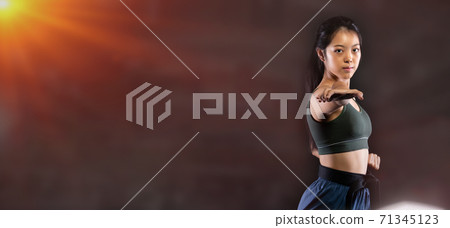 TaeKwonDo Karate teenager athlete kick punch black background isolated 71345123