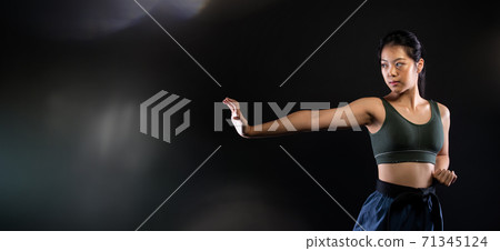 TaeKwonDo Karate teenager athlete kick punch black background isolated 71345124