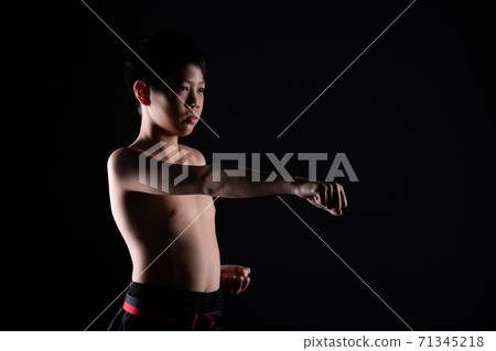TaeKwonDo Karate teenager athlete kick punch black background isolated 71345218