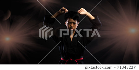 TaeKwonDo Karate teenager athlete kick punch black background isolated 71345227