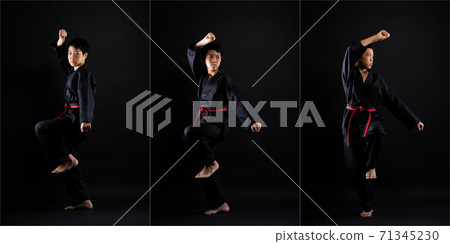 TaeKwonDo Karate teenager athlete kick punch black background isolated 71345230