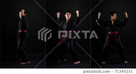 TaeKwonDo Karate teenager athlete kick punch black background isolated 71345231