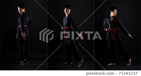 TaeKwonDo Karate teenager athlete kick punch black background isolated 71345237
