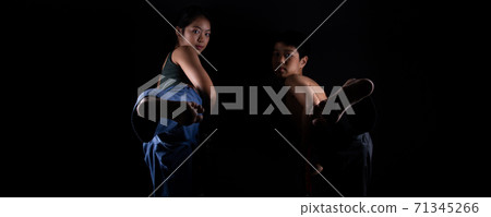 TaeKwonDo Karate teenager athlete kick punch black background isolated 71345266