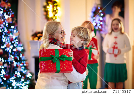 Family on Christmas day. Kids with gifts at door. 71345517