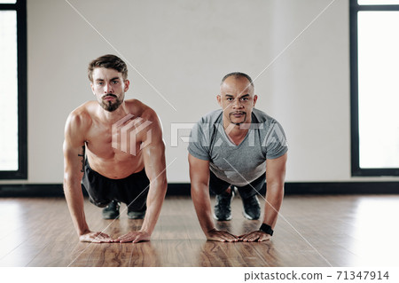Men doing heart push-ups 71347914