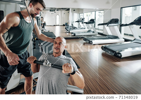 Man doing chest exercise Man doing chest exercise 71348019