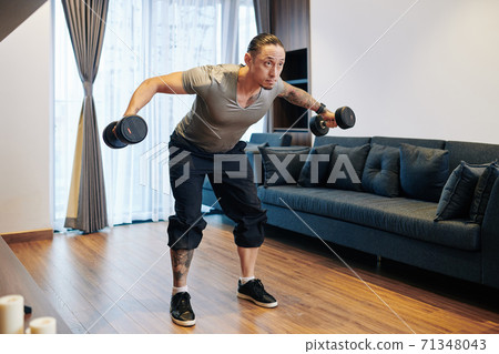 Man doing dumbbell flys Man doing dumbbell flys 71348043