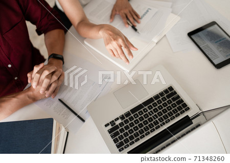 Young woman and man studying for a test or exam Tutor books with friends catching up and learning, education and school concept. 71348260