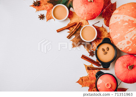 Autumn food. Frame of pumpkin puree soup, leaves. Top view. Autumn harvest, pumpkins, leaves on grey as abstract background. Thanksgiving day. Flat lay. Copy space Autumn food. Frame of pumpkin puree soup, leaves. Top view. Autumn harvest, pumpkins, leaves on grey as abstract background. Thanksgiving day. Flat lay. Copy space 71351963
