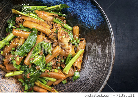 Thai pad see ew noodles with vegetable and minced beef offered Thai pad see ew noodles with vegetable and minced beef offered 71353131