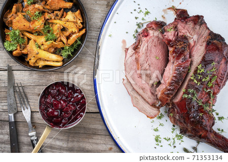 Marinated sliced barbecue dry aged leg of venison with chanterelles and cherry sauce 71353134