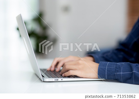 Hand of business man working from home using laptop computer to internet online on desk. Hand of business man working from home using laptop computer to internet online on desk. 71353862
