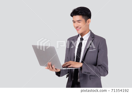 Young asian business man standing work on laptop computer to internet online isolated. 71354192